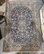 Persian blue ground handmade wool, cotton and silk 'Nain' rug with central floral medallion on