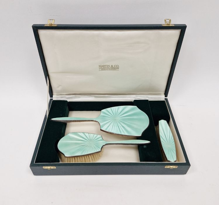 Cased set of silver mounted guilloche enamel dressing table set, comprising two brushes and a