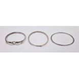 Silver bangle with ring and hook clasp, another flattened oval and another silver bangle, all marked