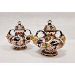 Pair of Crown Derby imari pattern two-handled squat formed vases and domed covers, late 19th