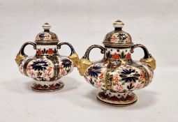 Pair of Crown Derby imari pattern two-handled squat formed vases and domed covers, late 19th