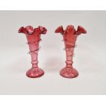 Pair of Victorian cranberry-coloured glass frill vases, each of tapering form applied with clear