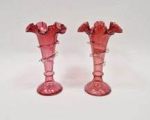 Pair of Victorian cranberry-coloured glass frill vases, each of tapering form applied with clear