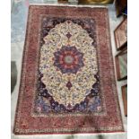 Pair of Persian handmade cream ground wool, cotton and silk 'Ispahan' rugs with large central