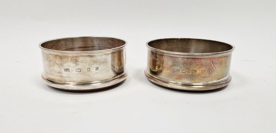 Pair of contemporary silver wine bottle coasters by Mappin & Webb, with wooden bases, hallmarked