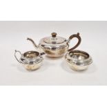George V three piece silver tea set, of bulbous form, the teapot with turned wooden knob and handle,