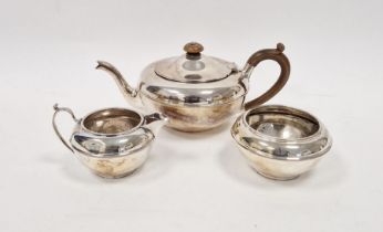 George V three piece silver tea set, of bulbous form, the teapot with turned wooden knob and handle,