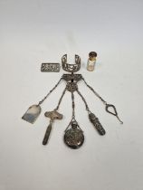 Continental white metal chatelaine with folding button hook, a bodkin case, a scent bottle,