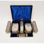 Cased George V silver mounted vanity set, comprising three brushes and one comb, hallmarked