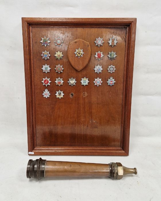 Mid-20th century wooden panel mounted with Fire Brigade badges including examples from