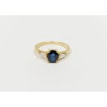 18ct yellow gold, sapphire and diamond ring set oval sapphire flanked by two tapering baguette-