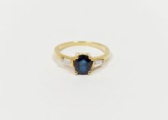 18ct yellow gold, sapphire and diamond ring set oval sapphire flanked by two tapering baguette-