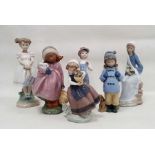 Five Lladro figures of children including a girl holding a white rabbit, another standing holding