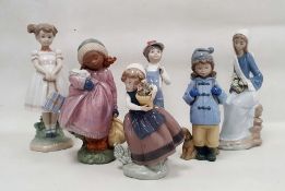 Five Lladro figures of children including a girl holding a white rabbit, another standing holding