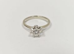 White metal and diamond solitaire ring, the brilliant-cut stone in raised claw setting, 0.75ct