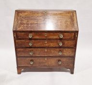 Georgian oak bureau, the fall front opening to reveal a selection of fitted drawers and pigeonholes,