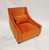 20th century low armchair, possibly by Parker Knoll, upholstered in orange fabric and a single