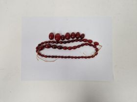String of red amber-coloured graduated oval beads Condition Report Some beads with light surface