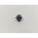 18ct white gold, sapphire and diamond cluster ring, the oval sapphire 2.3ct approx., the diamonds