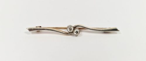 Gold-coloured metal and diamond bar brooch, the two collet-set stones within central scroll, each