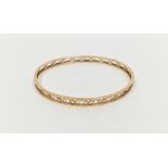 9ct gold slave bangle with shaped oval piercing, 10g approx.  Condition Report Light surface