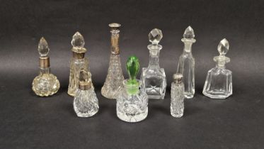 Collection of cut glass scent bottles, five having silver mounts, the largest measuring