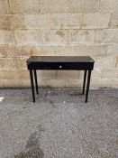 Contemporary black console/hall table of rectangular form with single drawer to the front, raised on