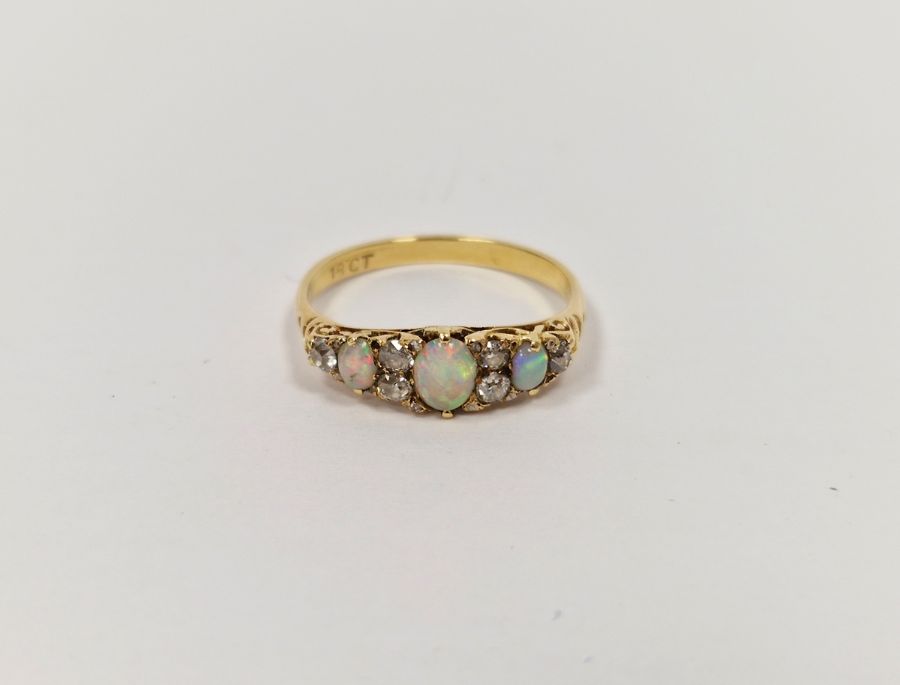 18ct gold, opal and diamond ring set three oval opals and six old cut diamonds  Condition Report