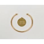 14ct gold engraved disc pendant, 2.6g approx. and a gold-coloured metal open bangle with ball