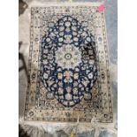 Persian blue ground handmade wool, cotton and silk 'Nain' rug with central floral medallion on woven