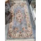 Chinese grey ground superwash rug with central floral oval medallion, floral border, 142cm x 92cm