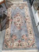 Chinese grey ground superwash rug with central floral oval medallion, floral border, 142cm x 92cm