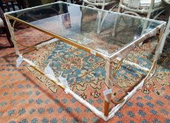 Contemporary glass-topped coffee table of rectangular form, raised on a gilt painted metal frame,