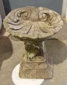 Composite stone birdbath in the shape of a shell 33cm high