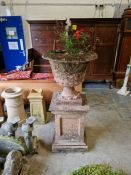 Large composite stone classical urn on square panelled pedestal to plinth base, the urn 65cm x