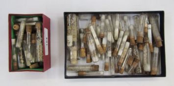 Numerous small glass phials with corks containing minute shells, small antique skull parts of