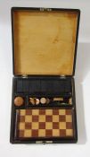 Early 20th century ebonised wooden travelling games compendium, with painted scene to lid