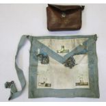Masonic apron in leather case with three masonic medals.