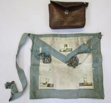 Masonic apron in leather case with three masonic medals.