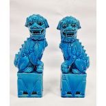 Pair of Chinese Kangxi-style turquoise-glazed models of lion dogs, 20th century, each modelled