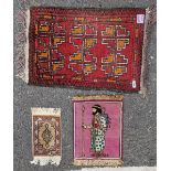 Middle Eastern silk miniature prayer rug and two wool examples, one with geometric medallions on a