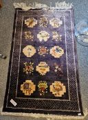 Chinese superwash rug, decorated with precious objects and fruiting trees, on a dark blue ground,