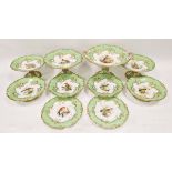 19th century English porcelain ornithological green ground dessert service, each painted with a