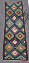 Maimana kilim runner, woven with lozenges in dark red, green, blue, yellow and cream, within a