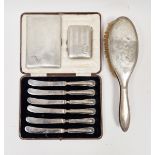 Set of six silver-handled tea knives, a silver cigarette case, engine-turned, another smaller and