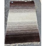 Contemporary rug in graduated shades of brown and cream with cream fringing, 126cm x 190cm