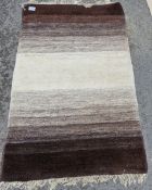 Contemporary rug in graduated shades of brown and cream with cream fringing, 126cm x 190cm