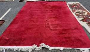 Contemporary deep red-pink ground carpet, probably Chinese Superwash, decorated with scrolling