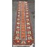 Middle Eastern wool runner, with central foliate band reserved on a salmon-coloured ground, in