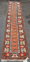 Middle Eastern wool runner, with central foliate band reserved on a salmon-coloured ground, in